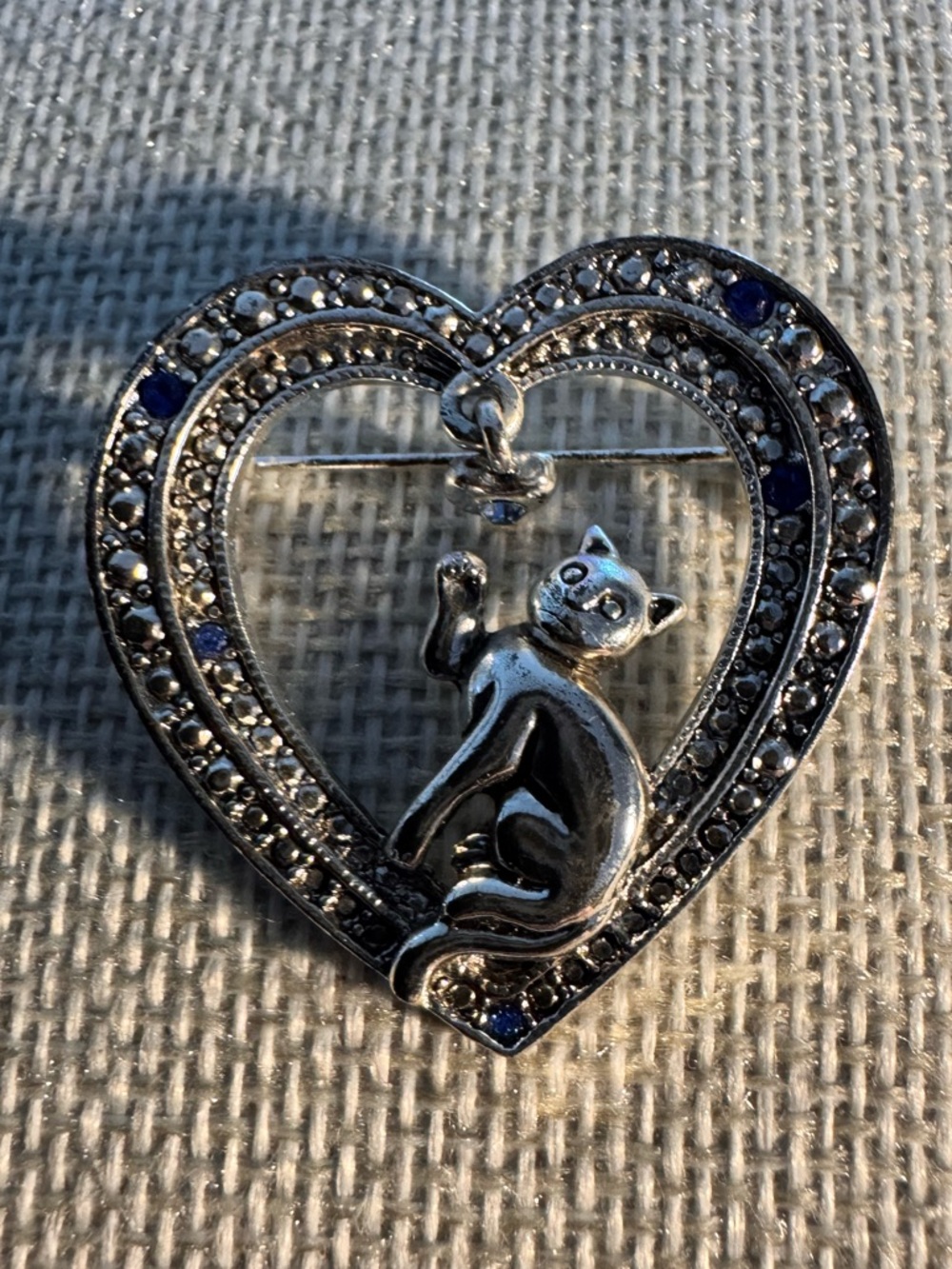 vintage silver-toned AAI cat brooch with blue rhinestones and a dangling charm
